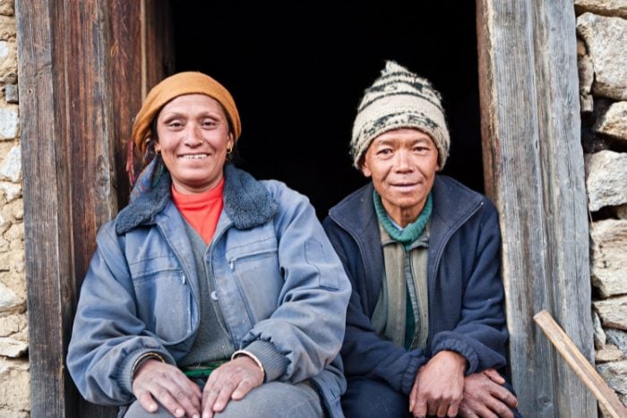 Nepali people sitting at their doorstep