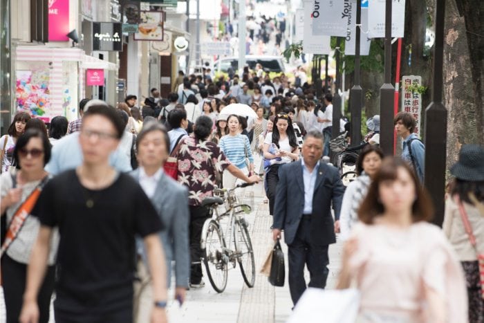 japanese people on a crowded pedestrian sidewalk