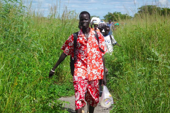 Sudanese people walking in fields
